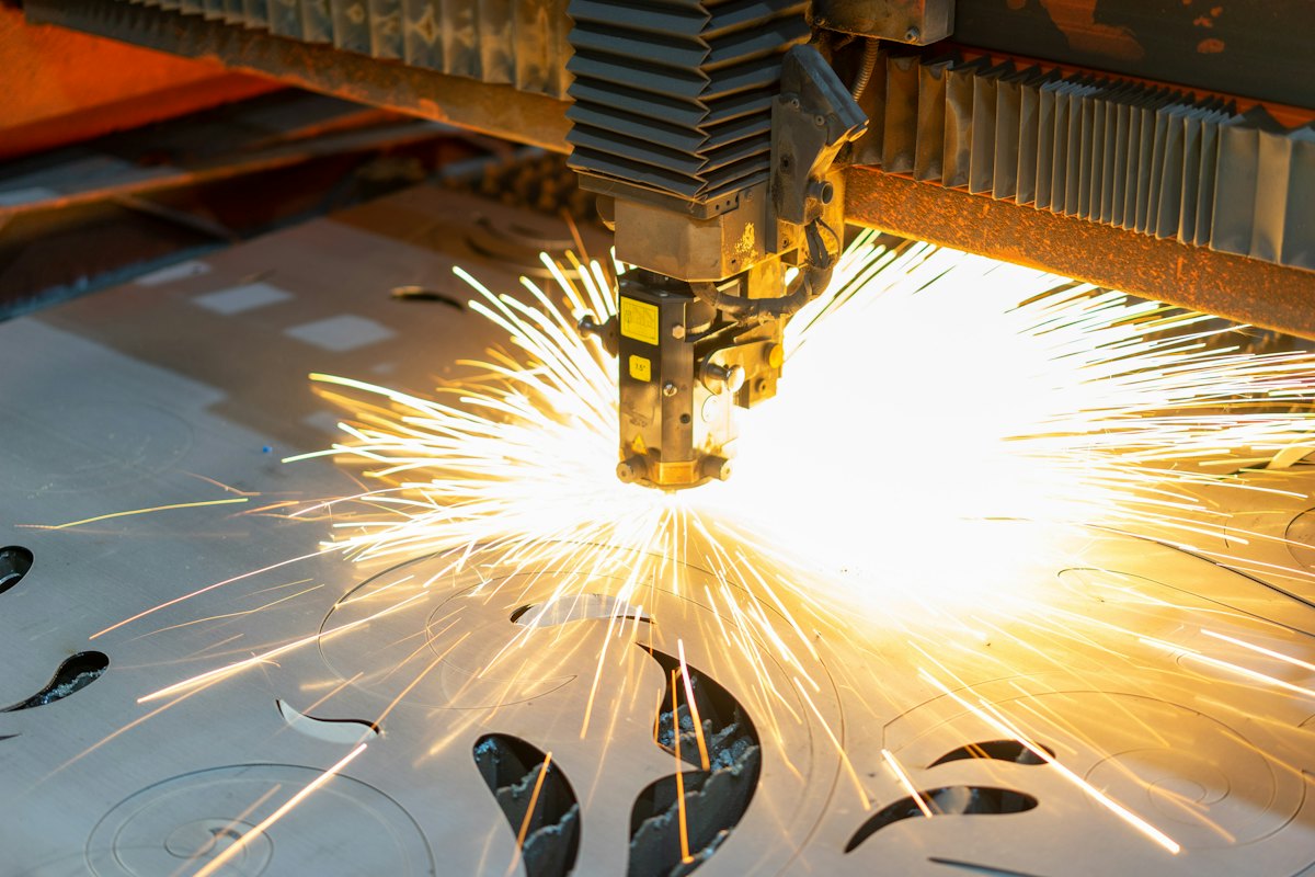 CNC cutting head burning shapes out of steel plate